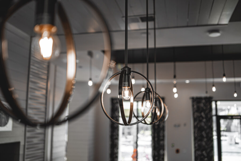 Selective focus shot of a modern lamp with a light bulb inside the building